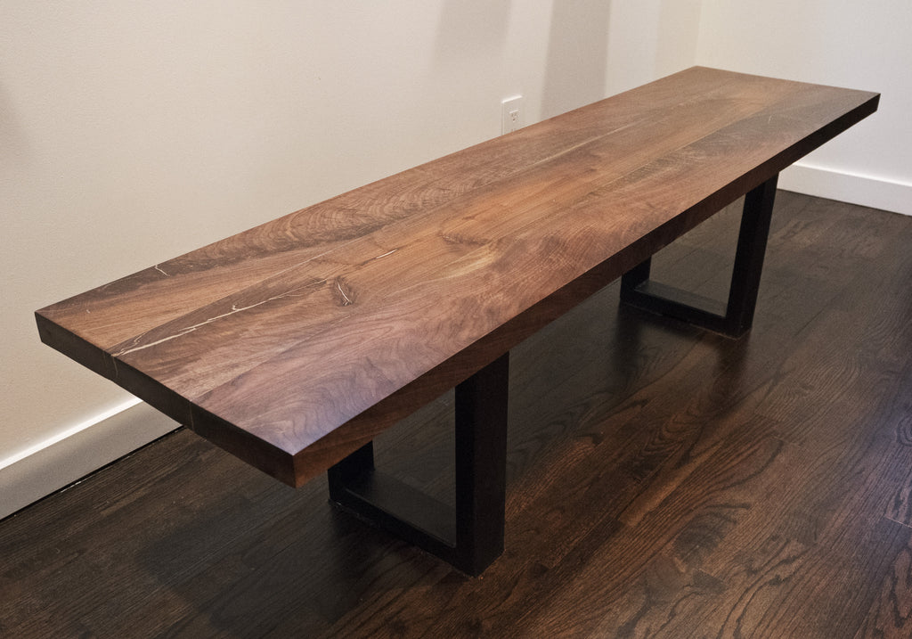 This sturdy solid wooden slab bench with steel legs is a rustic accent piece for any room. Our benches are handmade and can serve as a standalone piece or compliment any table or bench top.