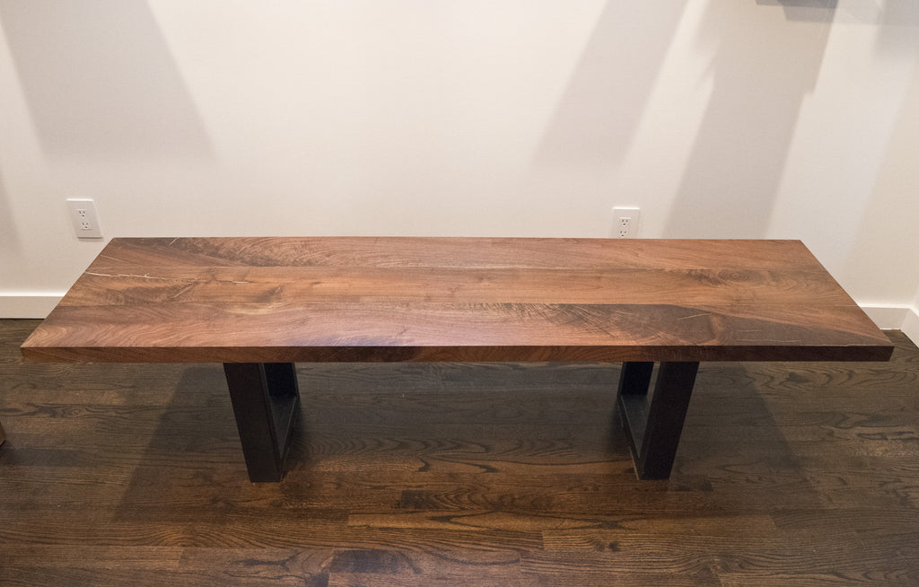 This sturdy solid wooden slab Walnut bench with steel legs is a rustic accent piece for any room.